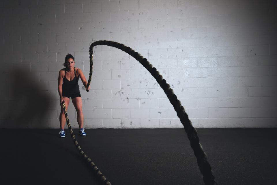 Athlete training with battle ropes